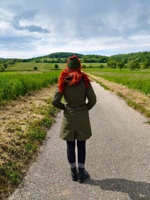 Karin von hinten mit Haube und Winterjacke beim Spaziergang